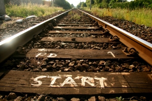 railroad tracks leading into the distance with "start" painted on a tie